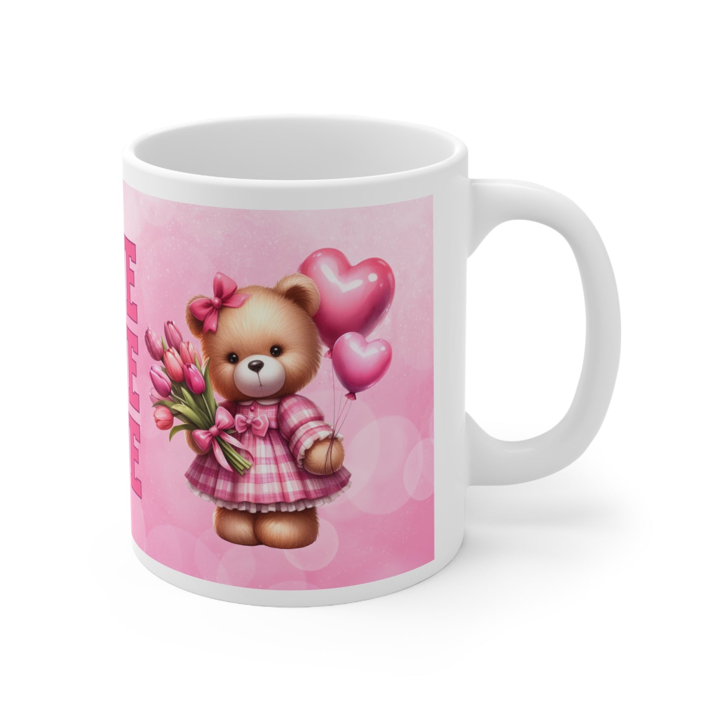 a pink and white teddy bear sitting next to a coffee cup 