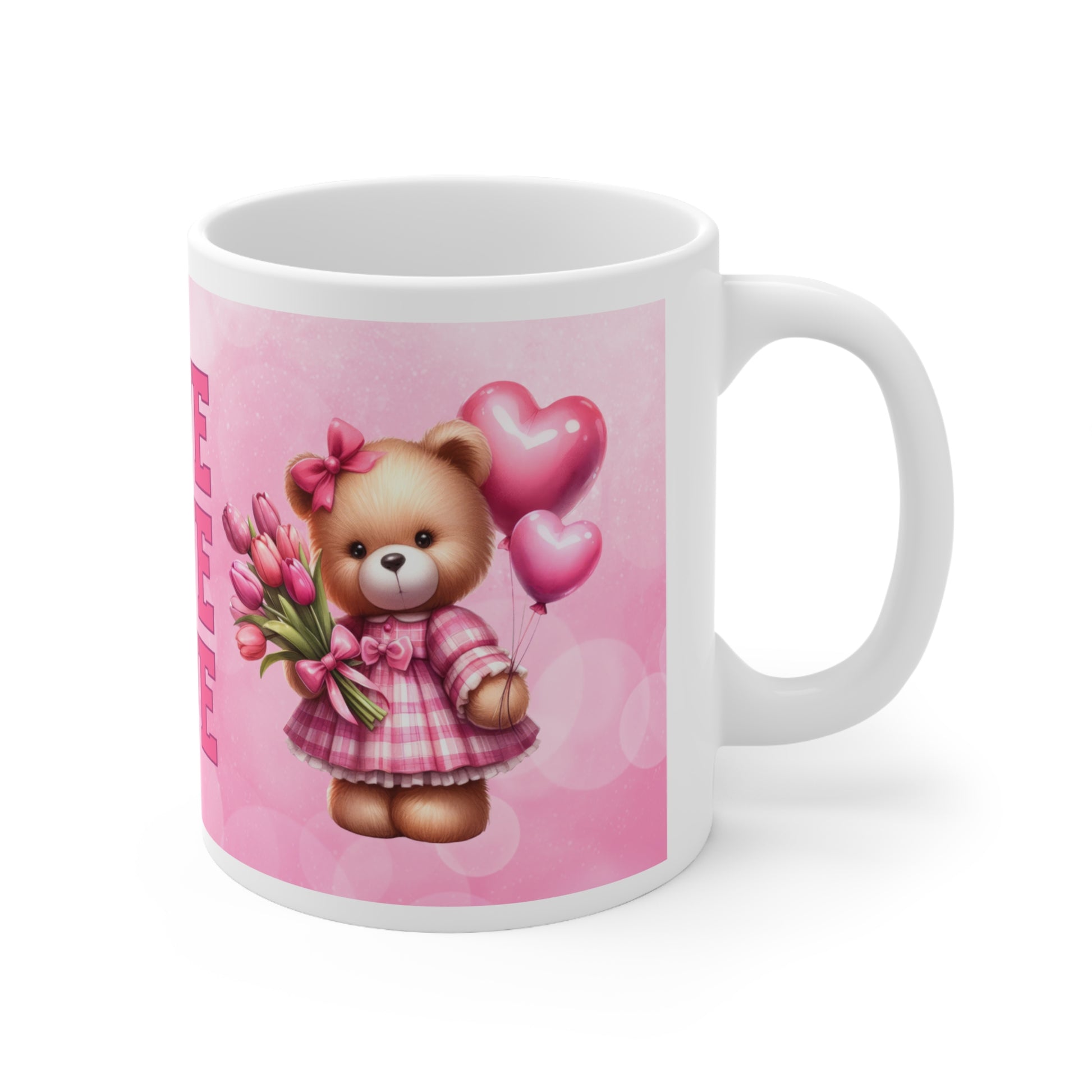 a pink and white teddy bear sitting next to a coffee cup 