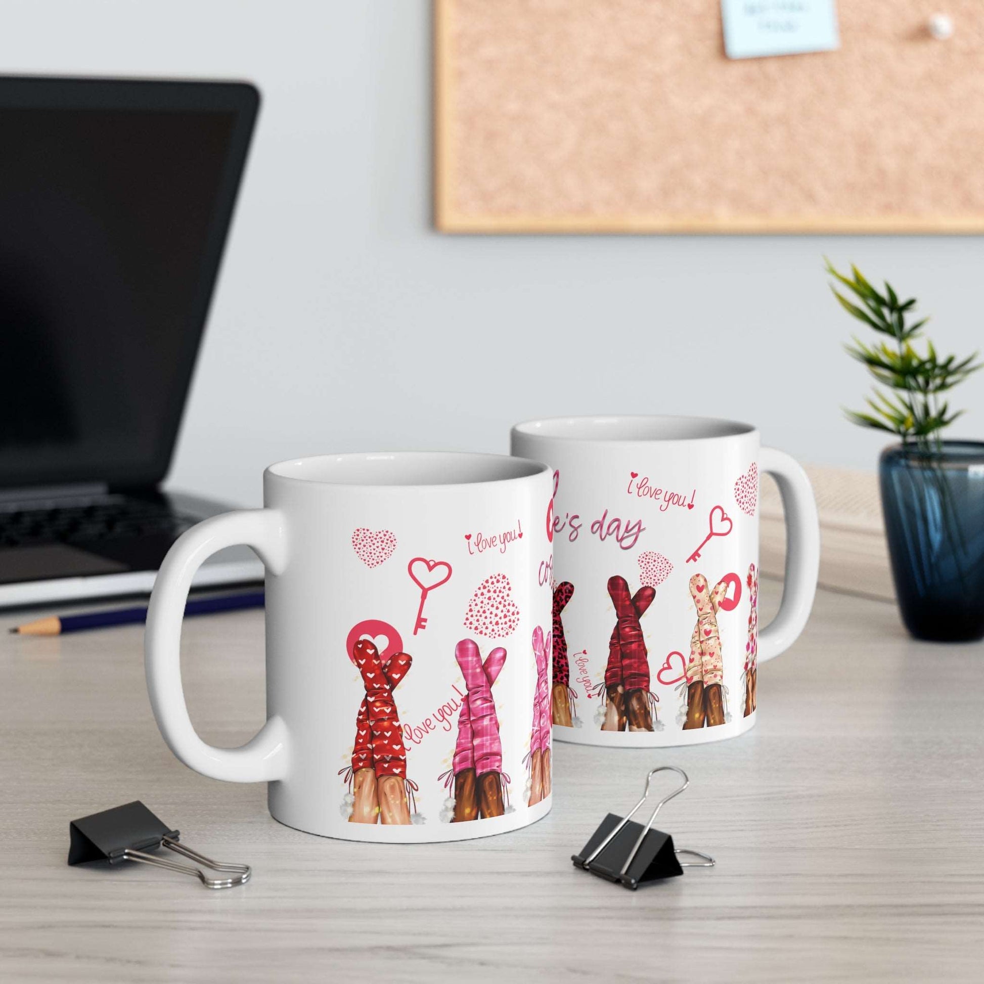 a coffee mug sitting on a table next to a coffee cup 