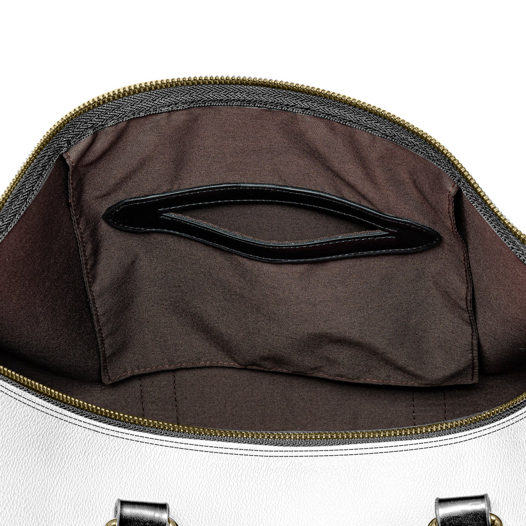 “Western-inspired women’s duffel bag displayed outdoors.”